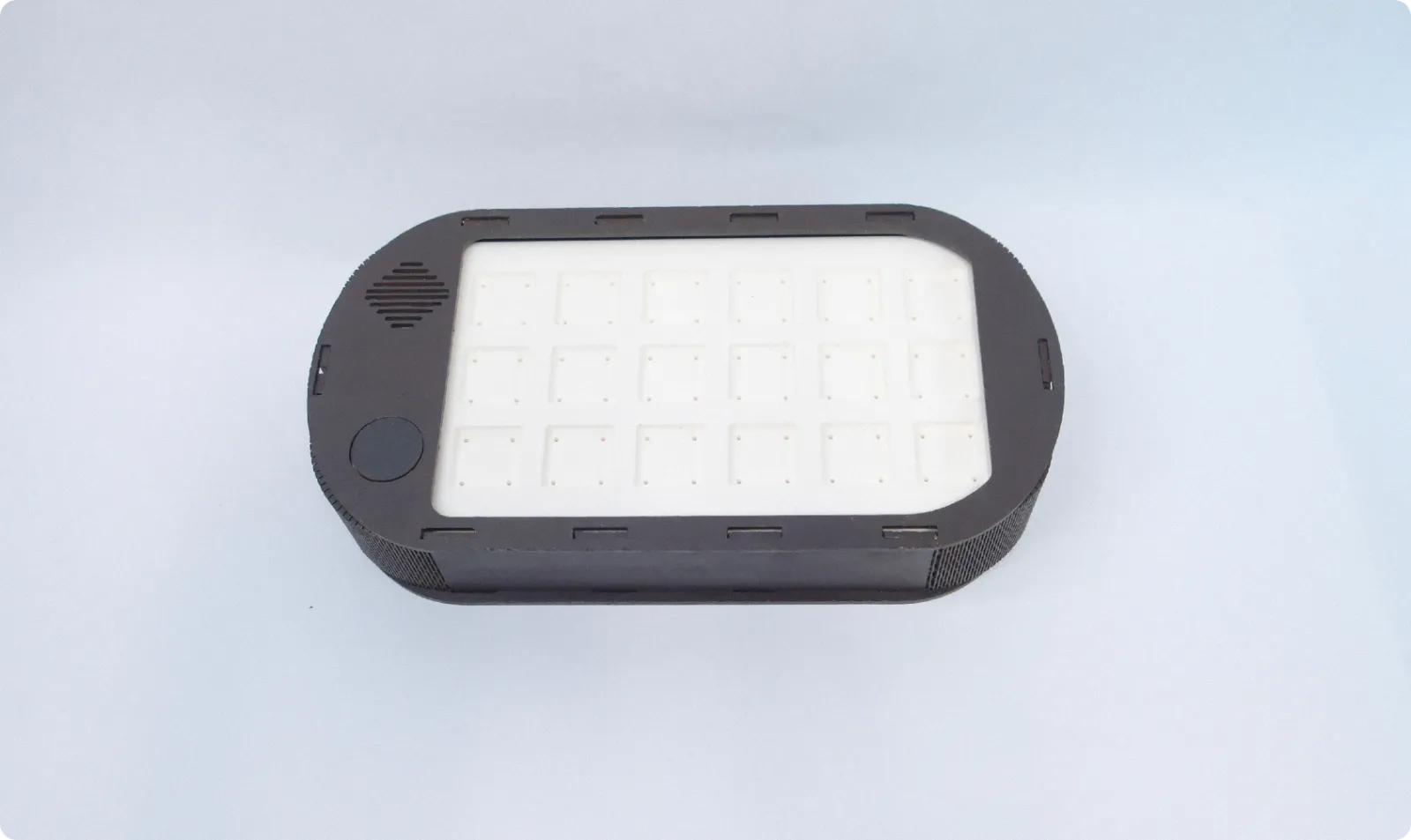 The laser-cut base with its grid of slots