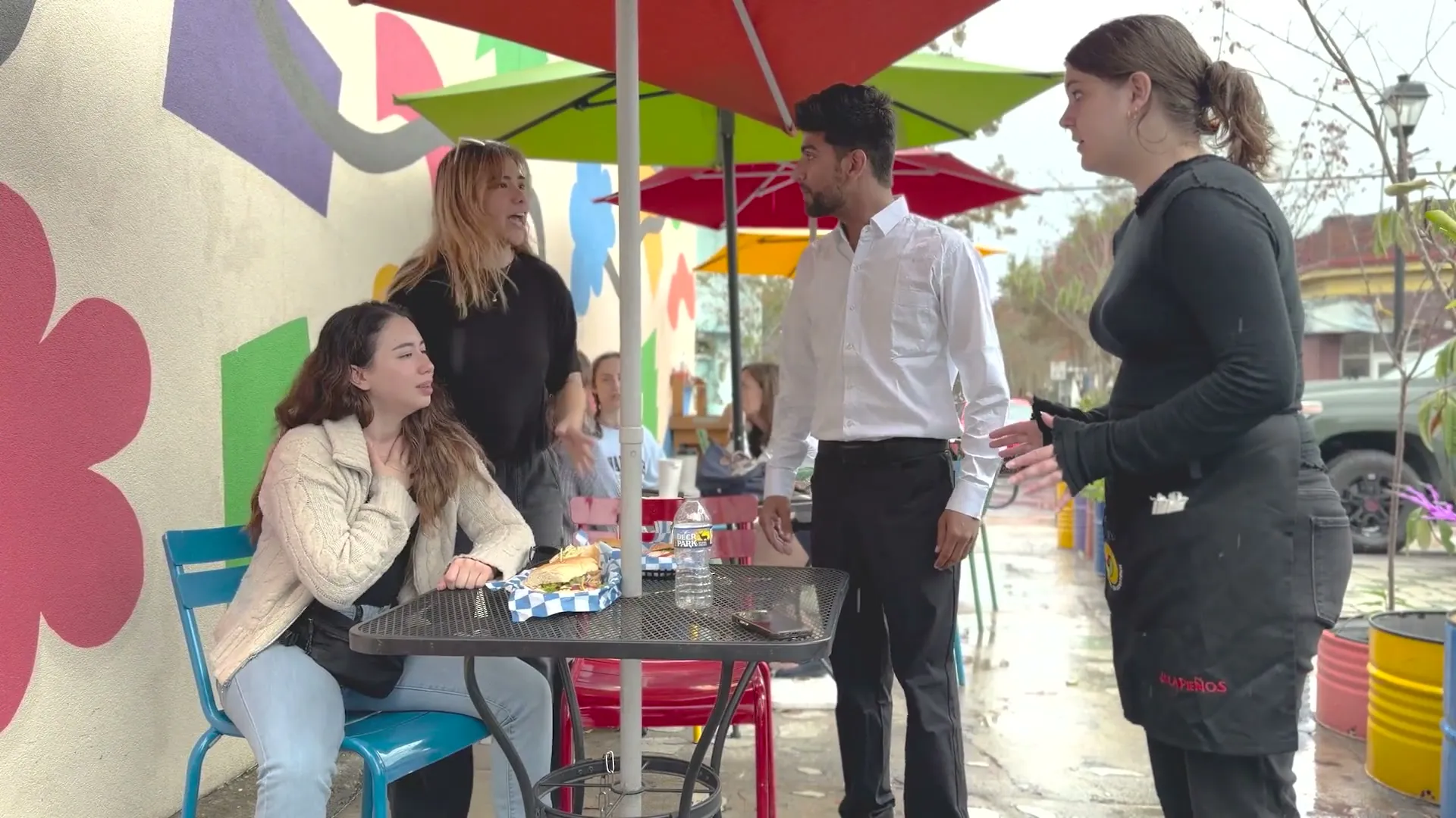 Still from the vision film: diners and staff at an outdoor table