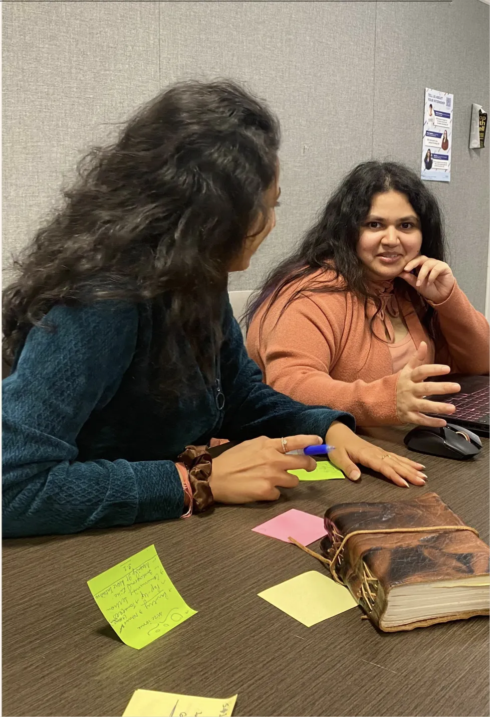 Two team members during an interview, with sticky notes on the table
