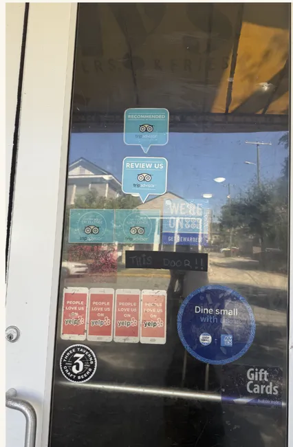 Stickers and notices on the restaurant door